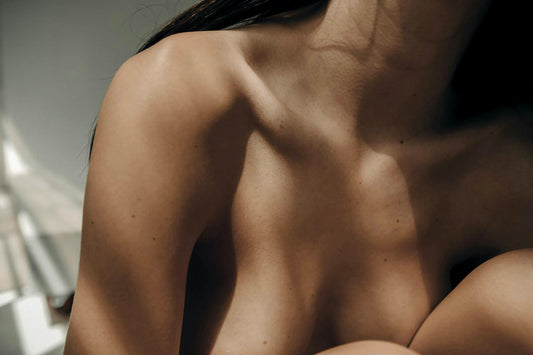 Close up of a woman's bare shoulder and neck — sensual self-care and body confidence — The Pleasure Space